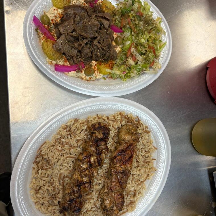 A gyro plate and kabab over rice