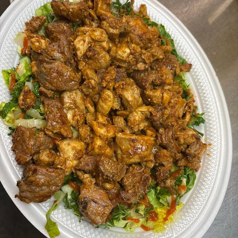 A large platter of chicken and beef